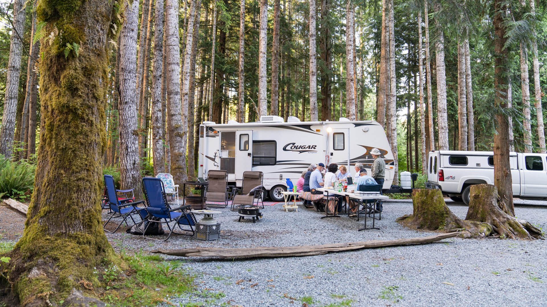Family camping outside Cougar travel trailer
