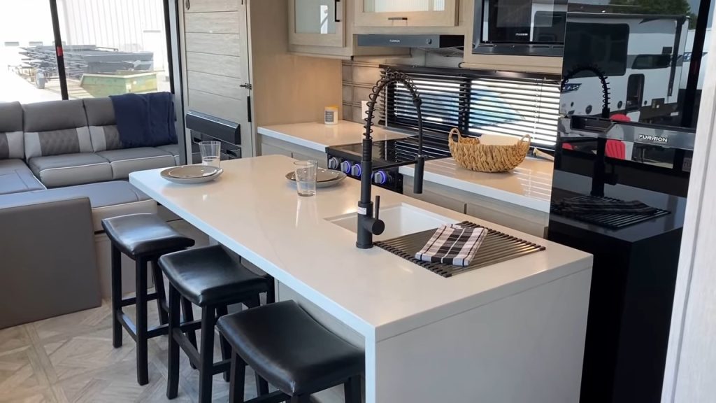 https://www.bishs.com/blog/wp-content/uploads/sites/504/2023/10/Completely-NEW-STYLE-of-RV-Design-2024-Wildwood-28VIEW-Travel-Trailer-13-22-screenshot-1024x576.jpg