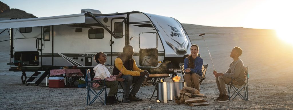 Jayco Jay Feather with Family camping outside