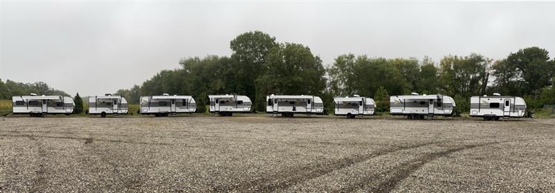 Eight Go Play Travel Trailers in a line outside