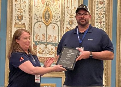 Bish's RV receiving service award from Lightspeed