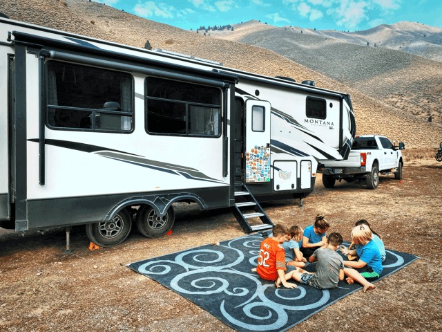 Kids playing outside their Montana 5th Wheel