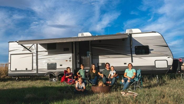 Family outside their Stick and Tin Travel Trailer