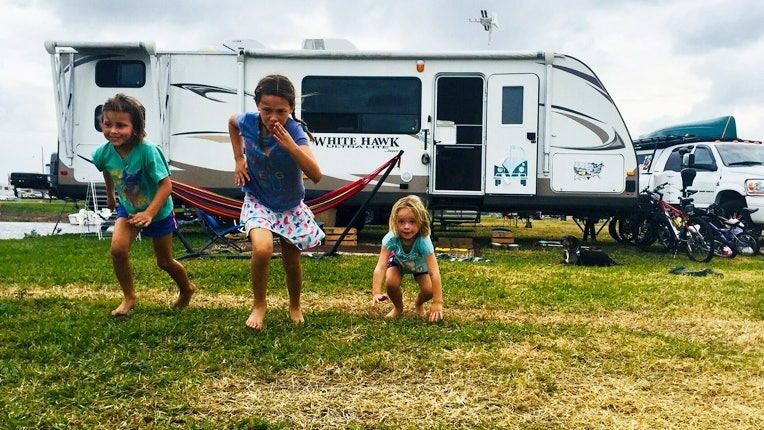 Kids playing outside a Jayco White hawk