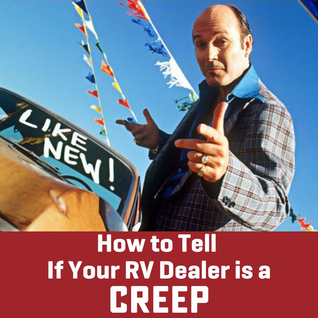 man in cheap flashy jacket with beat up old car behind him with sign that says Like new