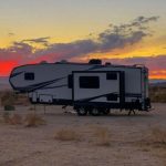 Fifth Wheel in the desert with a setting sun