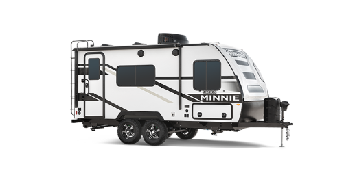 A white and black Minnie travel trailer with dual axles and a modern aerodynamic front cap. The trailer features multiple windows, two rooftop air conditioning units, exterior storage compartments, and a fold-down entry staircase. Designed for towing, it offers a sleek and contemporary RV design.