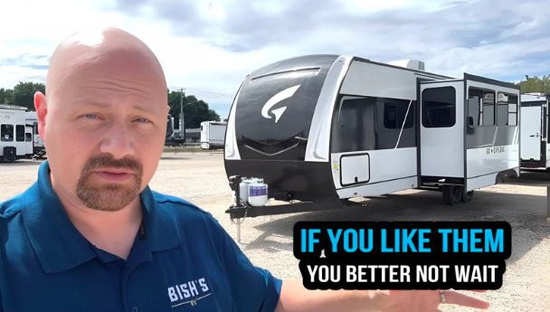 Josh the RV Nerd from Bish’s RV stands in front of a white and black Wayfinder Go Explore travel trailer with slide-out extended, pointing toward it with a caption overlay that reads “If you like them, you better not wait.