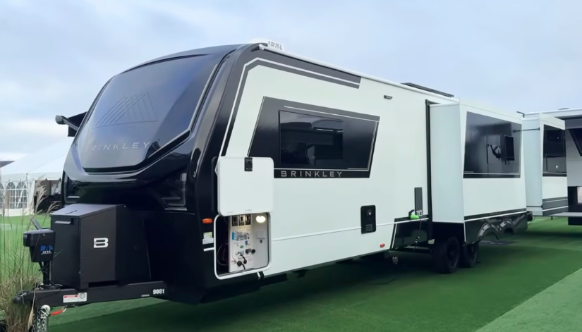 2026 Brinkley travel trailer with modern aerodynamic front cap, large slide-outs, and exterior utility bay open for display.