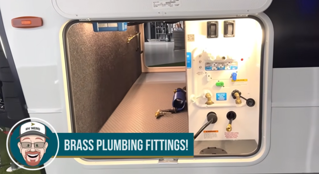 Pass-through storage and utility bay on the Brinkley Model I 280 featuring a clean Nautilus-style control panel with brass plumbing fittings, organized hose connections, and bright LED lighting. The large compartment showcases durable flooring and ample space for gear, reflecting Brinkley’s attention to quality and user-friendly design.