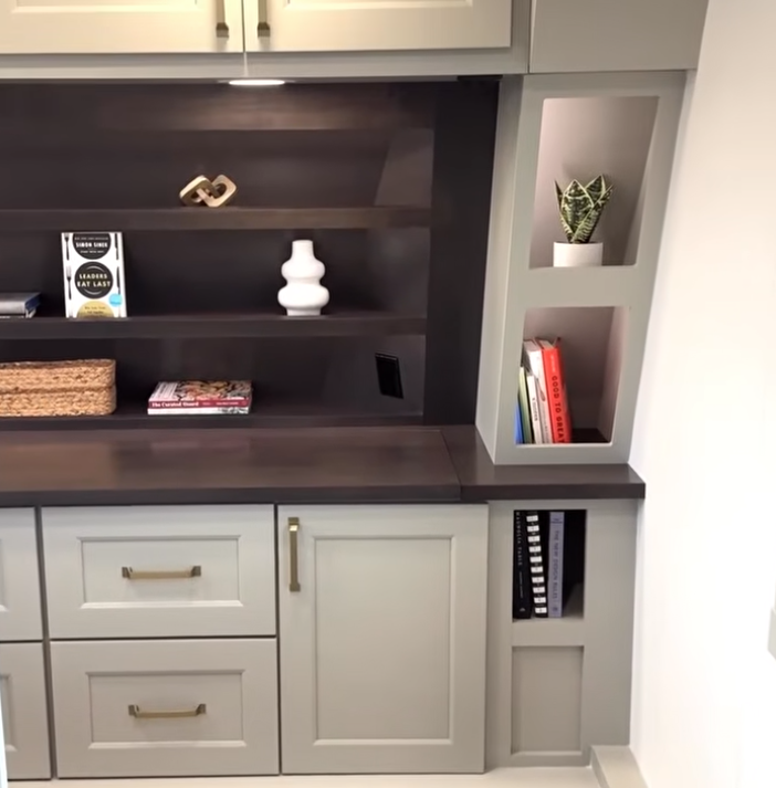 Adjustable height desk inside the 2026 Brinkley model G 4055 fifth wheel RV featuring an electric lift workspace with laptop, modern cabinetry, and wood-look flooring—ideal for remote work or creative use on the road.