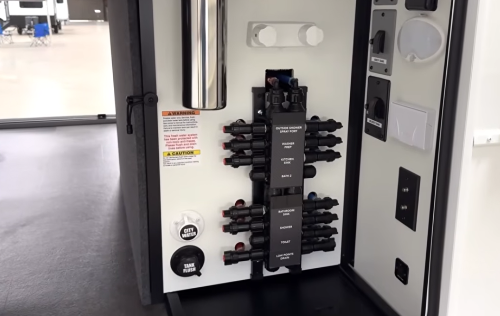 Alliance Paradigm utility control center with labeled water management system, city water and tank flush connections, and organized valve manifold for easy maintenance.