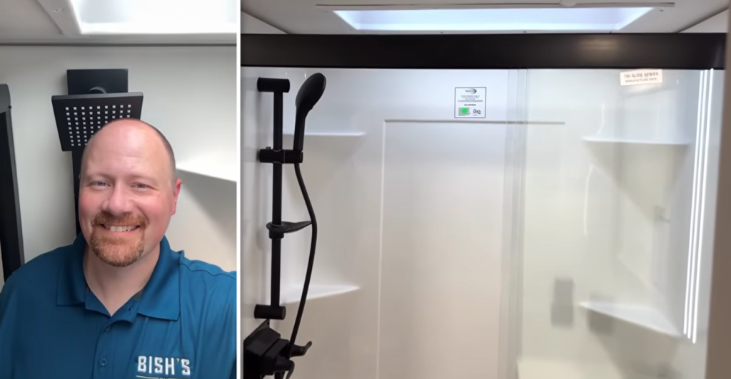 Spacious Alliance Paradigm fifth wheel shower with rainfall showerhead, adjustable handheld sprayer, and bright skylight for added headroom and natural light.