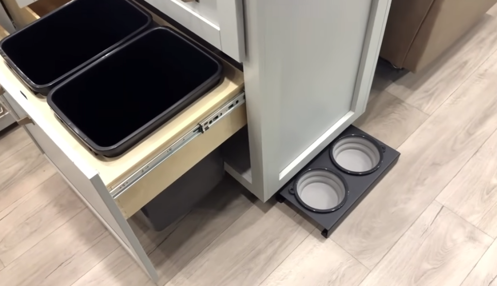 Brinkley Model Z RV kitchen with dual pull-out trash and recycling bins plus a built-in pet feeding station, highlighting innovative space-saving and pet-friendly design features.