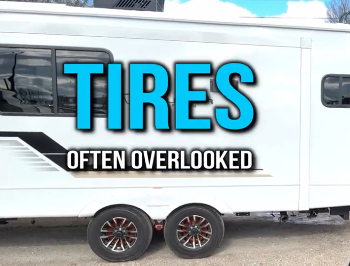 Side view of a white travel trailer with bold text reading “Tires Often Overlooked” — highlighting the importance of checking and maintaining RV tires for safety and longevity.