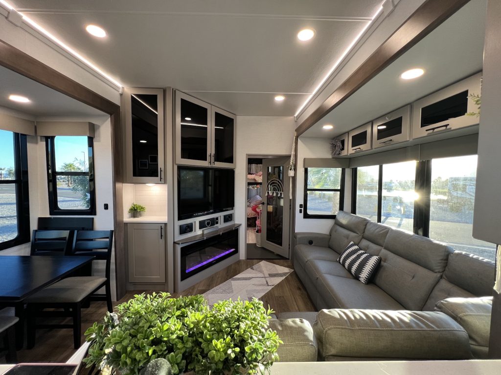RV toyhauler living room space showcasing the large TV and family seating area.