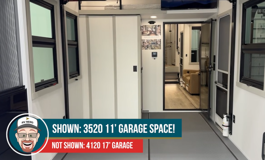Spacious Brinkley toy hauler garage interior showing the 3520 model’s 11-foot garage space with durable flooring, multiple windows, and a view into the living area through glass doors.