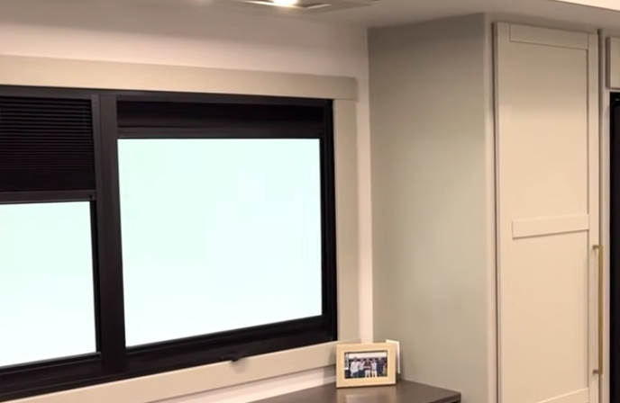 Brinkley Model Z 3200 interior featuring large RV window with blackout shades, built-in desk surface, and modern cabinetry with sleek trim.”