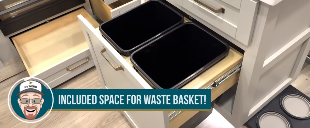 Brinkley Model Z 3200 RV kitchen pull-out wastebasket drawer with dual trash bins and soft-close cabinetry, shown with RV Nerd graphic highlighting included trash storage space.