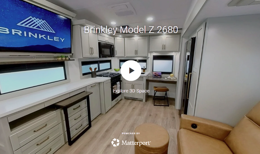 Brinkley Model Z 2680 interior featuring modern RV kitchen, entertainment center, workspace, and recliner seating, with a Matterport 3D tour preview.