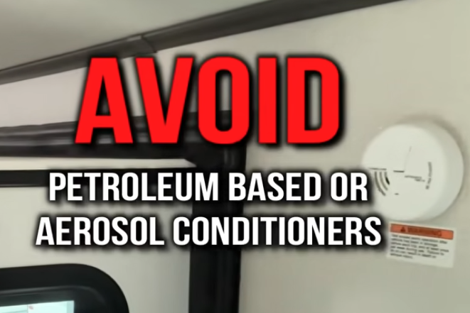RV interior wall with warning text overlay reading ‘Avoid petroleum based or aerosol conditioners,’ highlighting RV maintenance and safety advice.