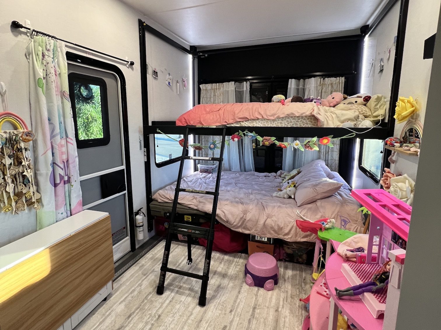 RV toyhauler area with bunk beds being used as a kid's bedroom