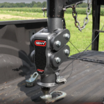 Close-up of a Gen-Y Torsion-Flex fifth wheel hitch with built-in shock absorption mounted in a pickup truck bed