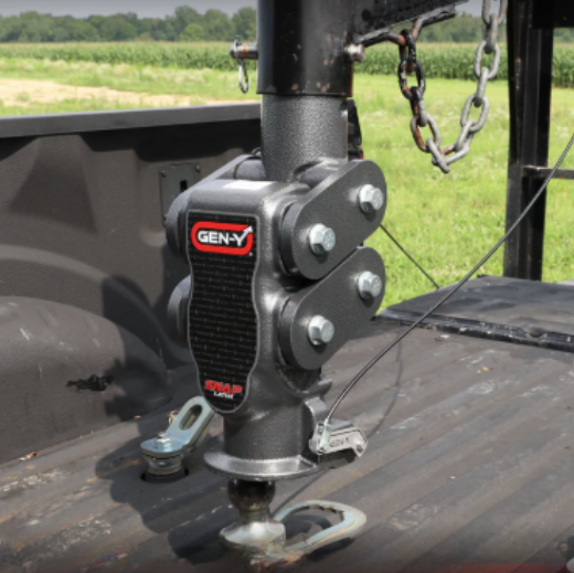 Close-up of a Gen-Y Torsion-Flex fifth wheel hitch with built-in shock absorption mounted in a pickup truck bed