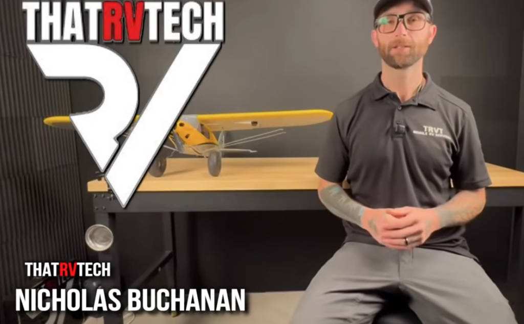 RV technician from ThatRVTech sitting in a studio with model airplane and ThatRVTech branding on screen