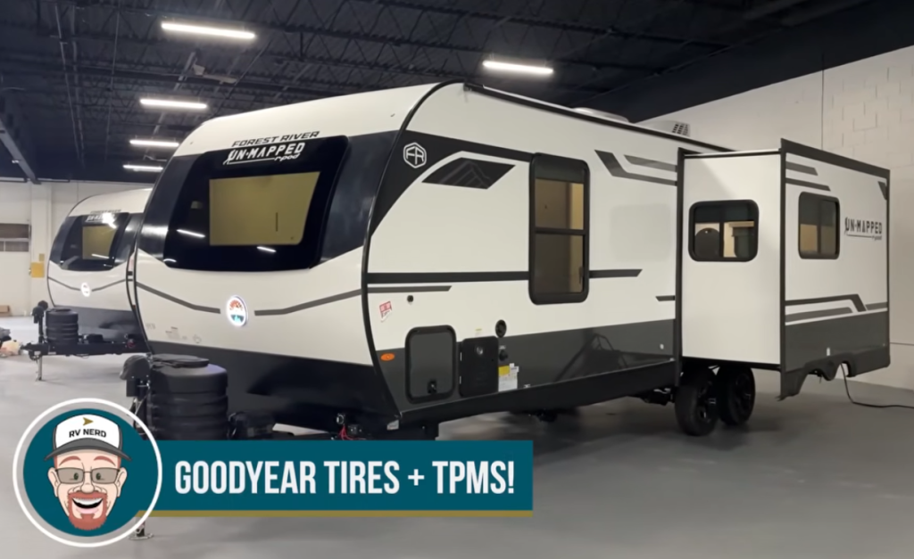 Forest River Unmapped r-pod travel trailer with slide-out extended in indoor showroom