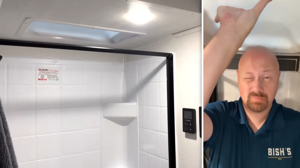 RV shower with skylight and control panel while Bish’s RV staff member points to ceiling
