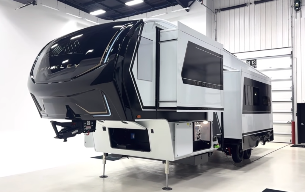 Brinkley luxury fifth wheel RV with slide-out extended inside a showroom