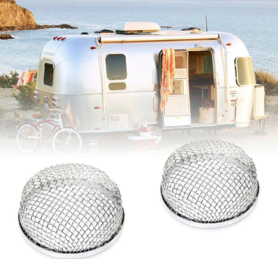 RV parked by the ocean with metal mesh vent covers shown in foreground