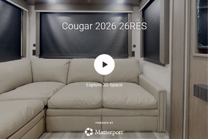 Interior of Cougar 2026 26RES travel trailer showing rear sofa seating with overlay text for 3D tour preview.