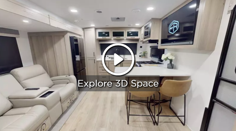 Modern travel trailer interior with theater seating, a kitchen island with bar stools, overhead cabinetry, and a wall-mounted TV, shown with a 3D tour overlay.