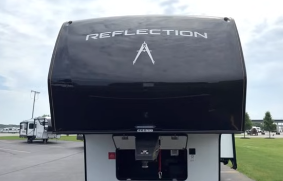 Front view of a Grand Design Reflection fifth wheel RV showing the hitch area and large branded front cap.