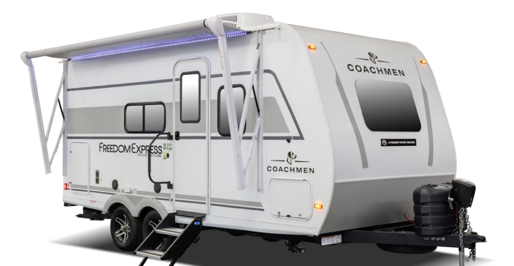 Coachmen Freedom Express travel trailer with white exterior, dual axles, extended awning, and LED accent lighting shown on a white background