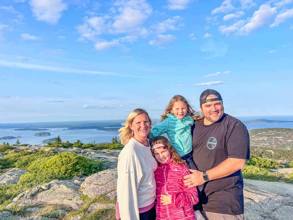 family standing on top of Cadillac Mountain
