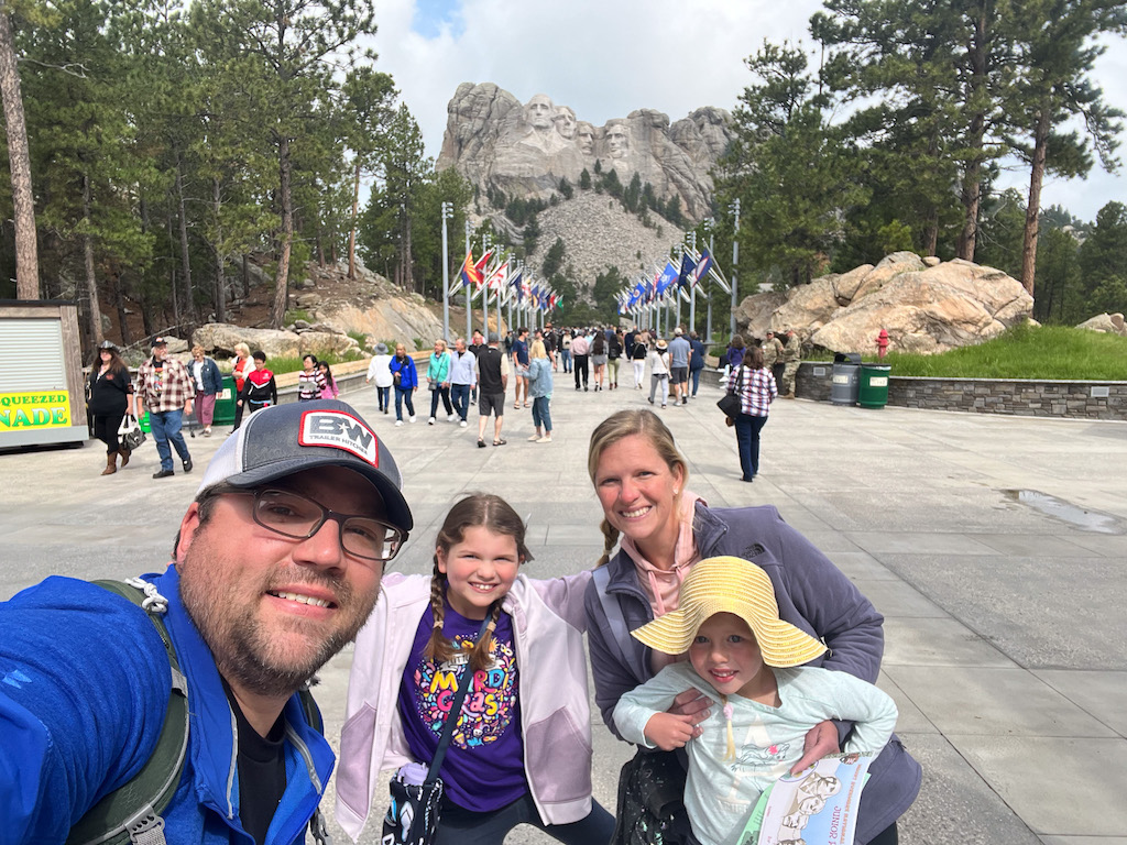 Family standing in front of Mount Rushmore
