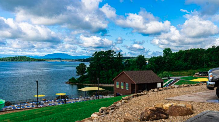 Lakeside RV resort overlooking a scenic mountain lake, featuring waterfront campsites, a shoreline recreation area, landscaped grounds, and panoramic views that create a relaxing destination for RV travelers and outdoor enthusiasts