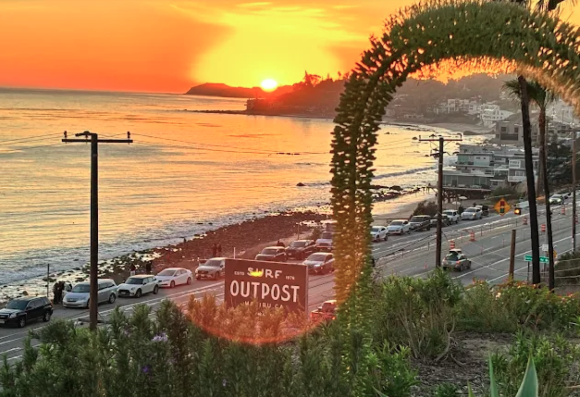 Sunset view overlooking the Pacific Ocean from Surf Outpost RV Resort in Malibu, California. The image captures vibrant coastal colors, oceanfront scenery, and sweeping views of the shoreline, highlighting the resort’s prime location along the iconic Southern California coast