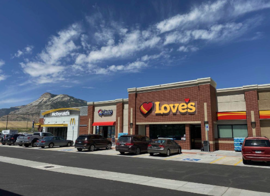 Love's Travel Stop with convenient fuel pumps, restaurant options, and ample parking for travelers. Popular with RV owners and road trippers, Love's provides fuel, food, clean restrooms, travel essentials, and overnight conveniences, making it a common stop for long-distance RV travel and cross-country camping adventures.