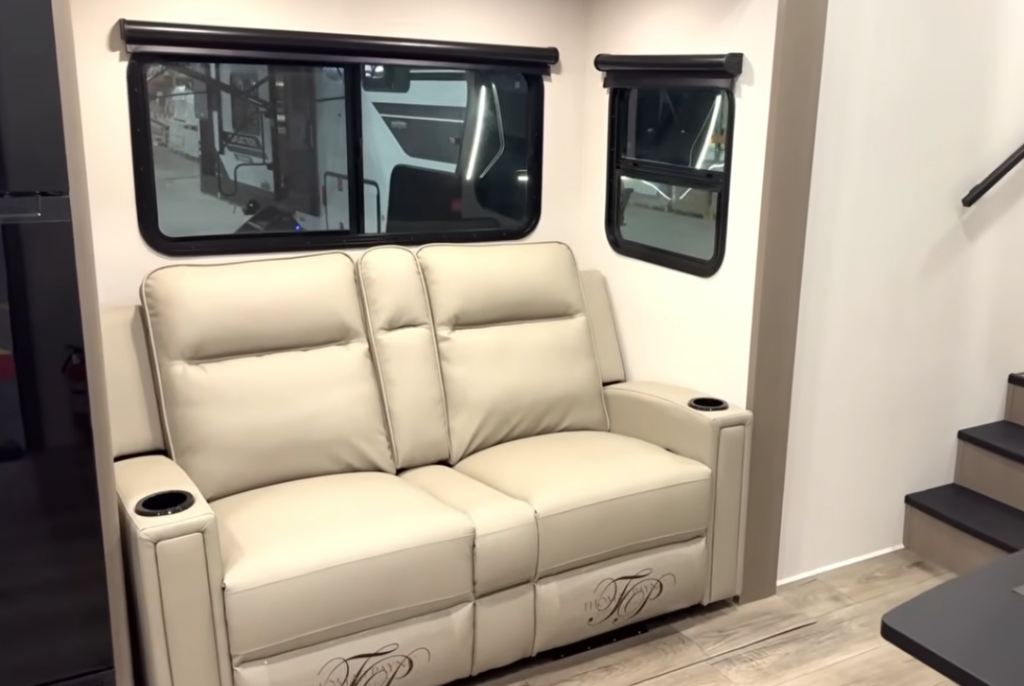 Luxurious dual reclining theater seating with integrated cup holders in the living area of a premium RiverStone fifth wheel.