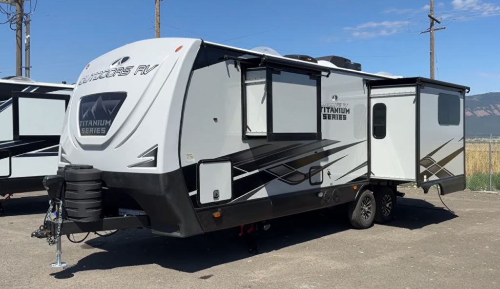 Exterior view of the Outdoors RV Titanium Series travel trailer with dual slide-outs extended, showcasing its spacious floorplan and rugged construction.