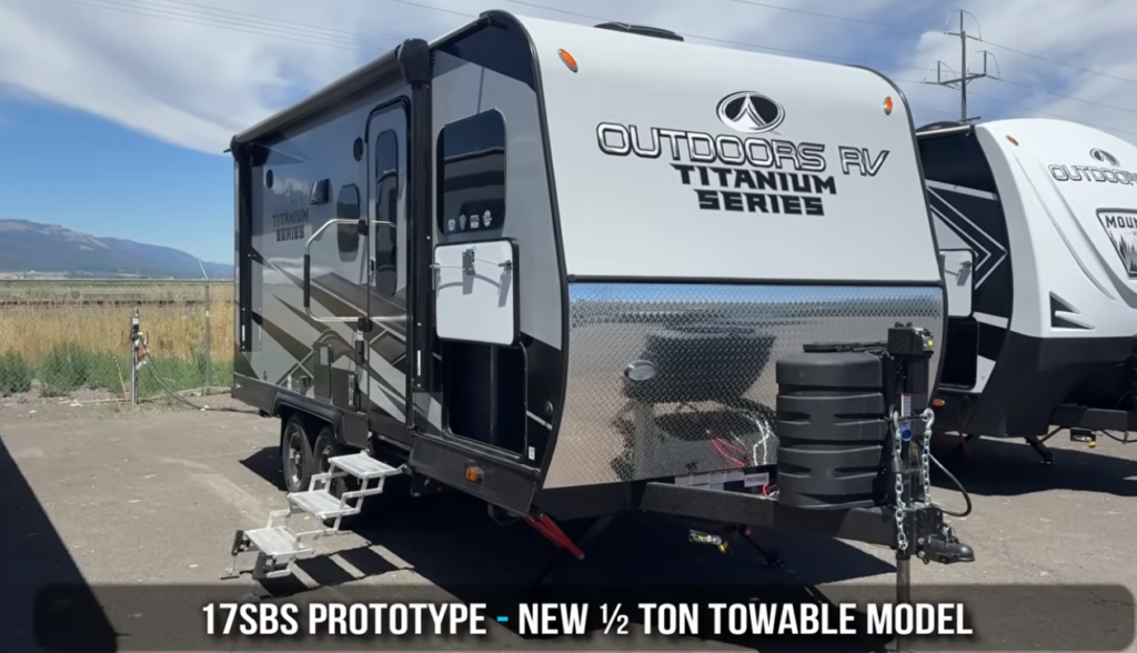 Front three-quarter view of the Outdoors RV Titanium Series 17SBS prototype travel trailer, a lightweight half-ton towable model designed for couples and small families.